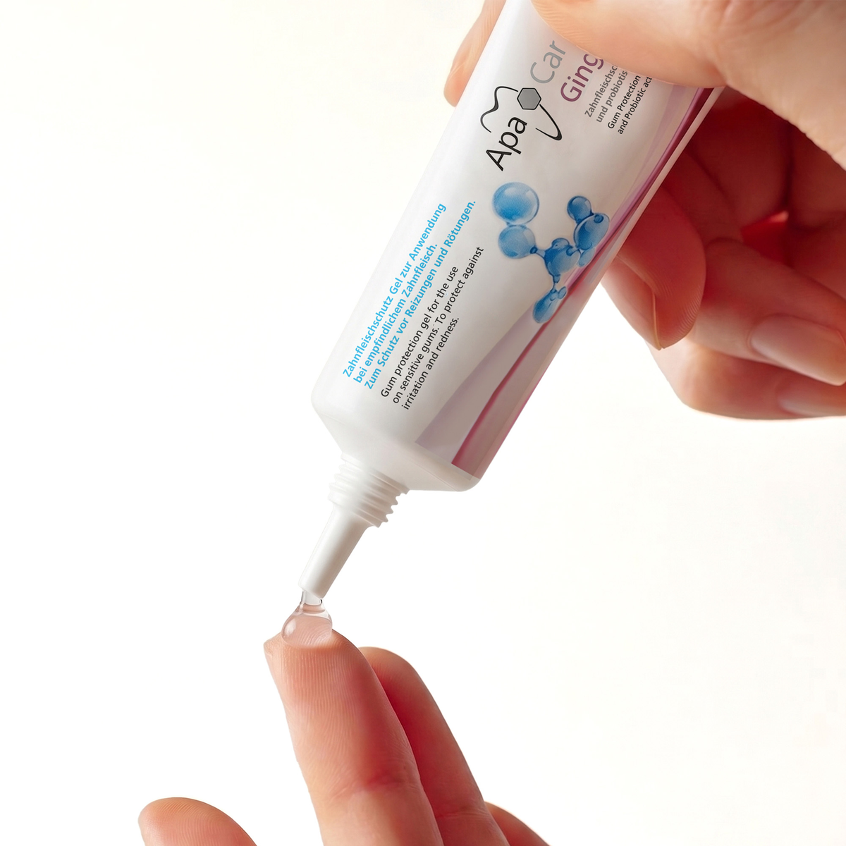 Squeezing ApaCare Gingiva Gel onto a fingertip