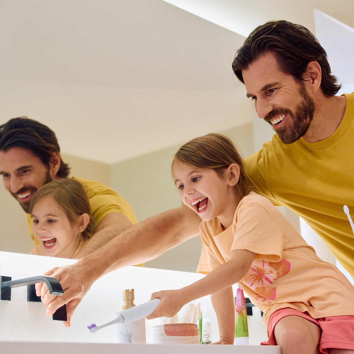 Family brushing teeth together with ApaCare Kids Toothpaste